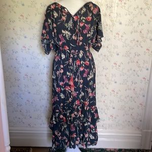 Flouncy rayon dress with ruffle details and tassel belt. Size L.